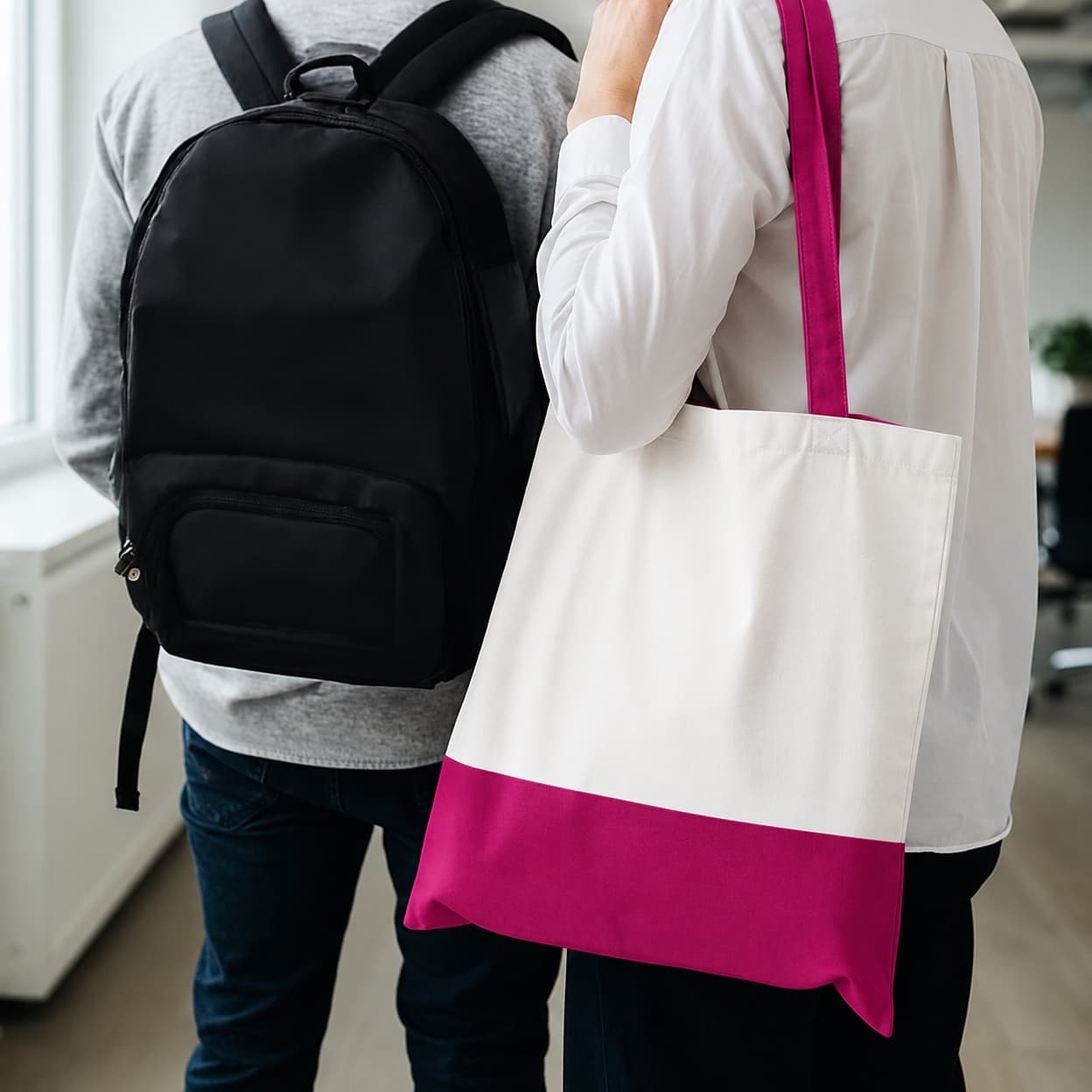 A black backpack and a two-tone tote bag carried over the shoulder.
