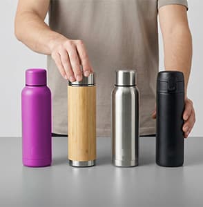 A wall display of textile items like hats and bags.